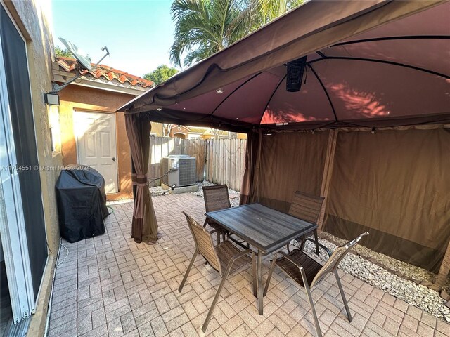 view of patio with a gazebo, grilling area, and central AC