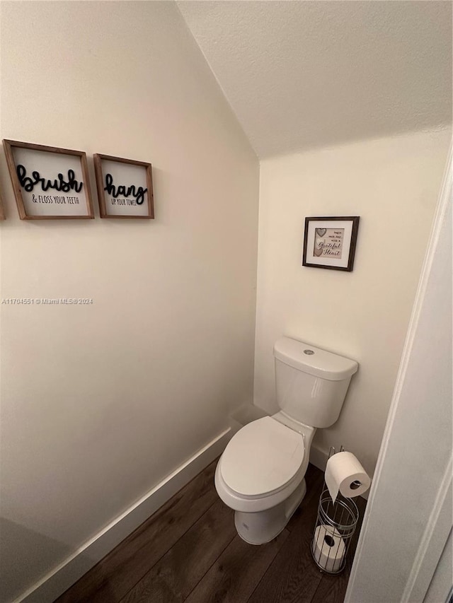 bathroom with hardwood / wood-style floors and toilet