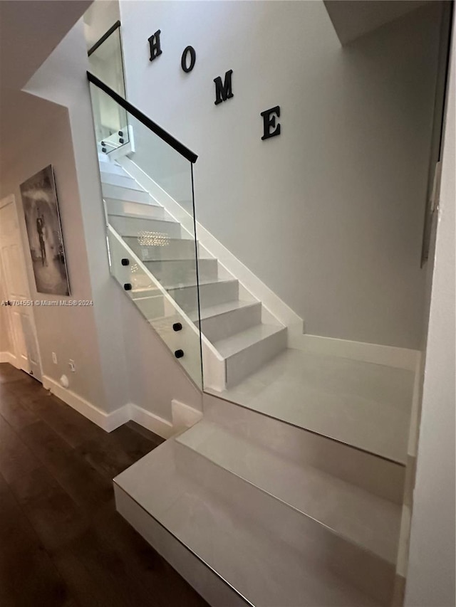 stairs featuring hardwood / wood-style flooring