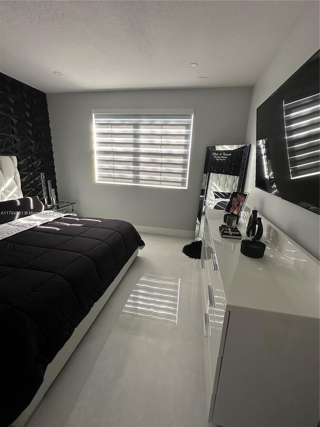 tiled bedroom with a textured ceiling