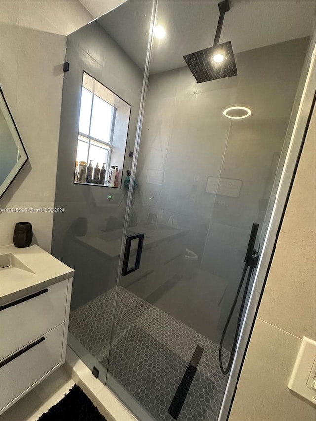 bathroom with vanity and a shower with shower door