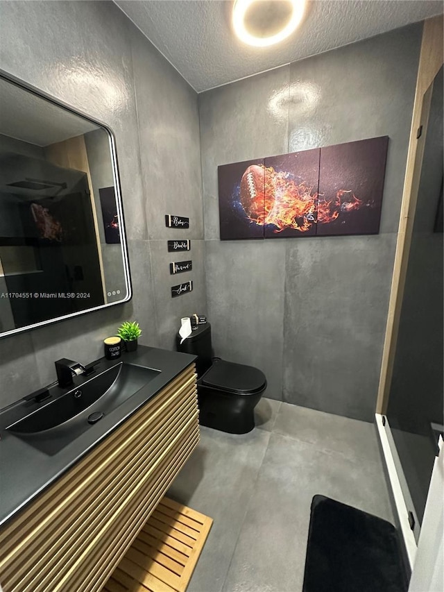 bathroom with a shower, concrete flooring, a textured ceiling, toilet, and vanity