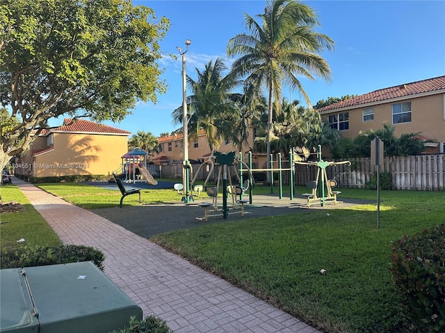 view of home's community with a lawn and a playground