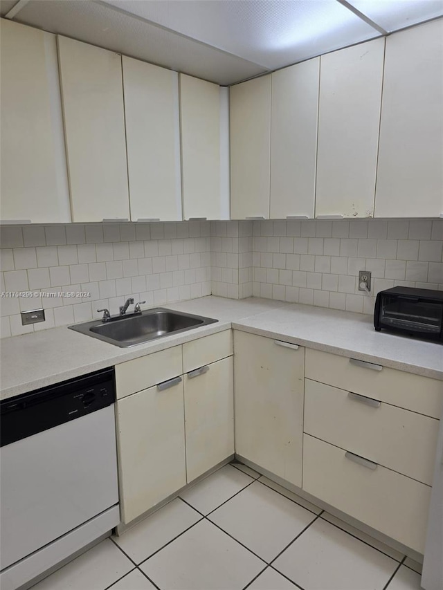 kitchen with dishwasher, light tile patterned flooring, decorative backsplash, and sink