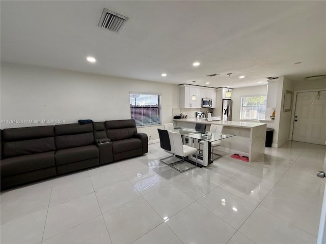 living room featuring light tile patterned flooring and sink