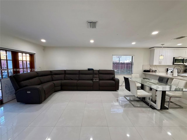 tiled living room featuring a wealth of natural light and french doors