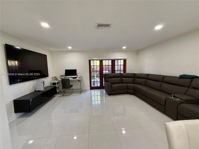 living room featuring light tile patterned floors and french doors