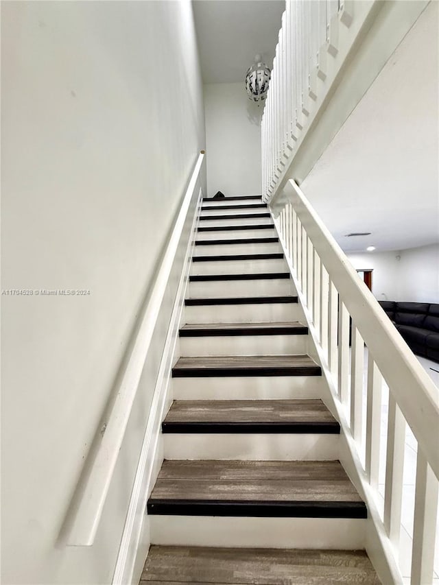 staircase featuring hardwood / wood-style flooring