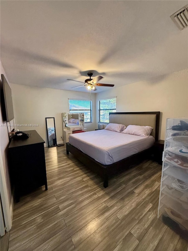 bedroom featuring ceiling fan and dark hardwood / wood-style flooring