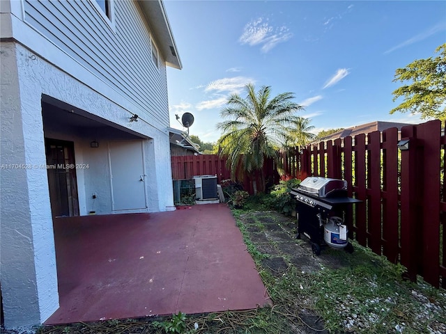 view of yard featuring central air condition unit and a patio