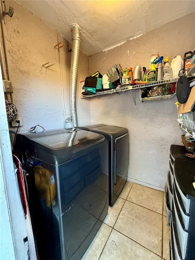 laundry area with tile patterned floors and separate washer and dryer