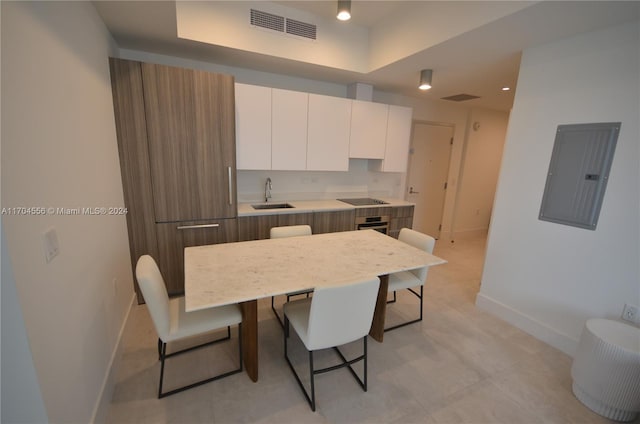 239 SW 9th St Unit 1603, Miami, FL 33130 - kitchen with electric panel, modern cabinets, white cabinets, black electric cooktop, and light countertops