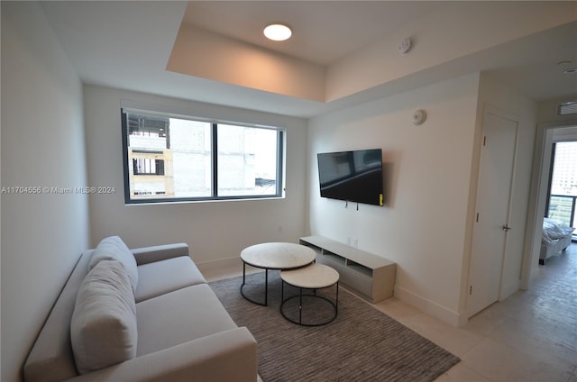 239 SW 9th St Unit 1603, Miami, FL 33130 - living area featuring healthy amount of natural light, a tray ceiling, and light tile patterned flooring