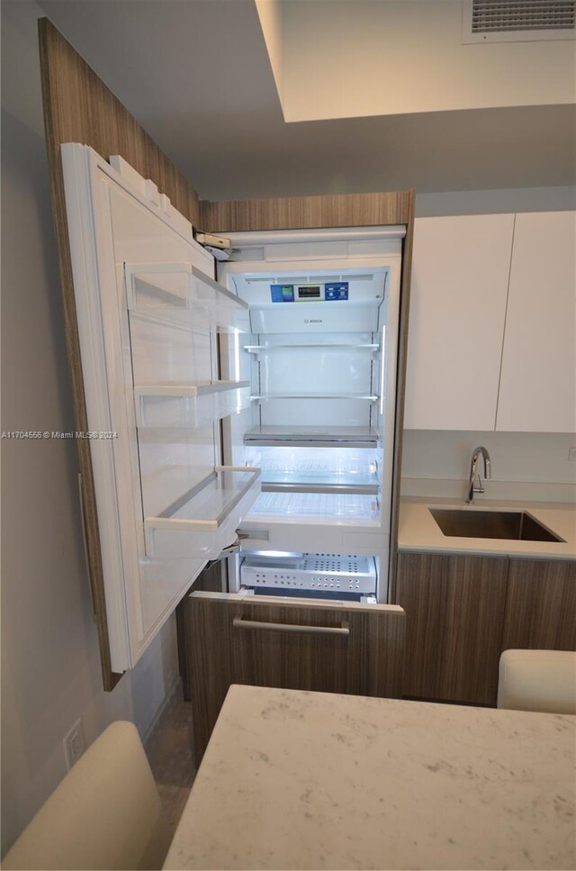 239 SW 9th St Unit 1603, Miami, FL 33130 - kitchen with white cabinetry, modern cabinets, and light countertops