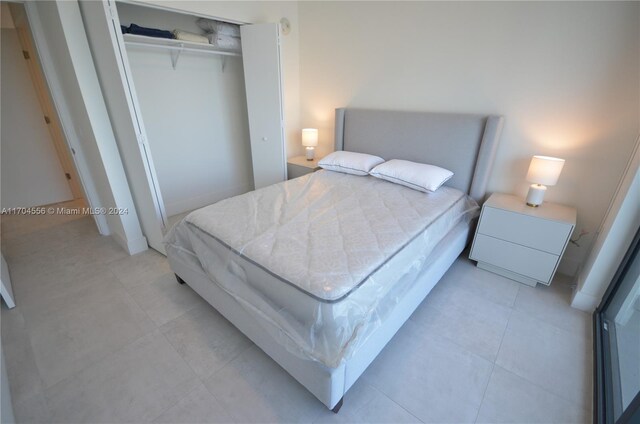 239 SW 9th St Unit 1603, Miami, FL 33130 - bedroom featuring a closet and light tile patterned floors
