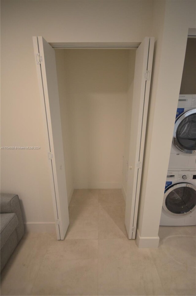 239 SW 9th St Unit 1603, Miami, FL 33130 - laundry room featuring stacked washer / dryer and light tile patterned floors