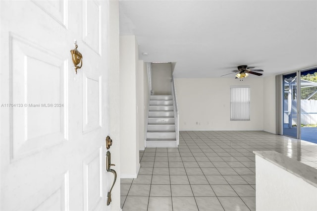 tiled foyer with ceiling fan