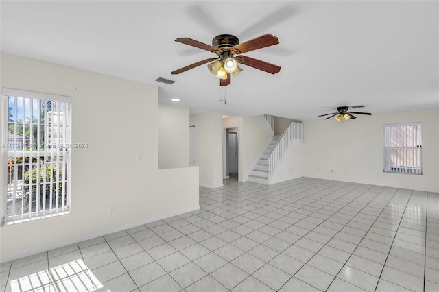 tiled empty room with ceiling fan