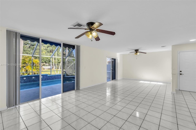 tiled empty room featuring ceiling fan