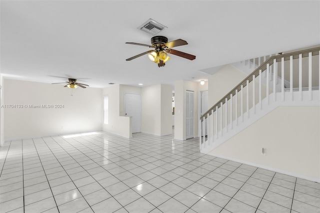 empty room with ceiling fan and light tile patterned floors