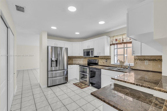 kitchen with white cabinets and appliances with stainless steel finishes