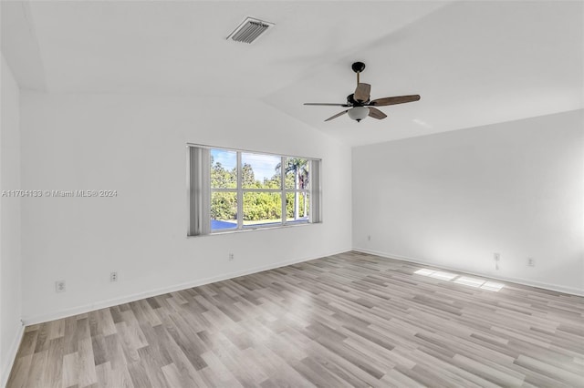 spare room featuring ceiling fan, vaulted ceiling, and light hardwood / wood-style flooring