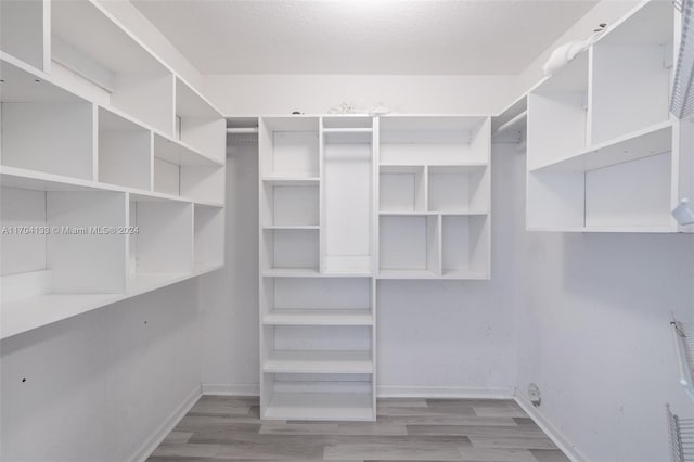 walk in closet featuring hardwood / wood-style floors