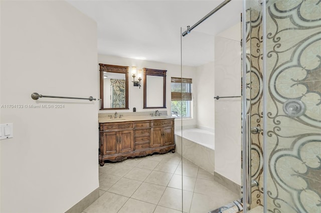 bathroom featuring vanity, tile patterned floors, and tiled tub