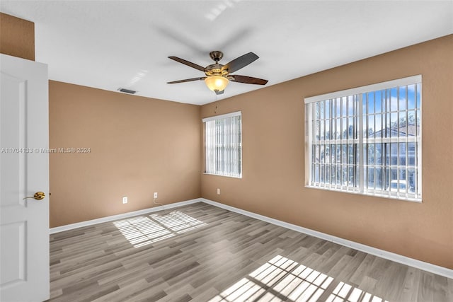 empty room featuring ceiling fan and light hardwood / wood-style floors