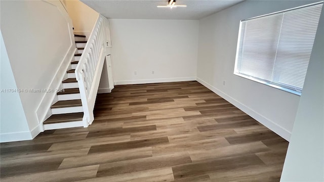 interior space featuring wood-type flooring and a textured ceiling