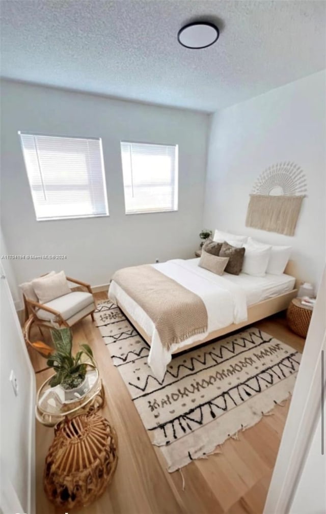 bedroom with hardwood / wood-style floors