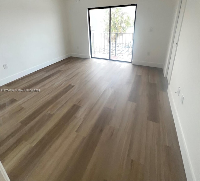 empty room featuring dark wood-type flooring