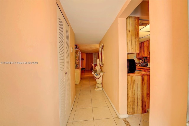 hall featuring light tile patterned floors