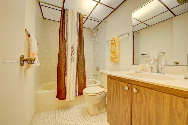 full bathroom featuring tile patterned flooring, vanity, toilet, and shower / bath combo with shower curtain