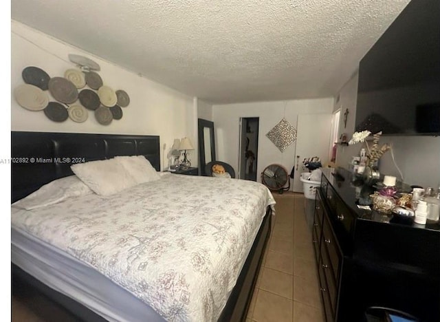 tiled bedroom with a textured ceiling