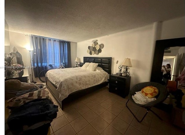 bedroom featuring tile patterned flooring and a textured ceiling