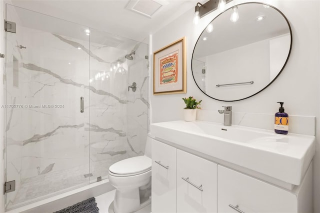 bathroom featuring vanity, an enclosed shower, and toilet