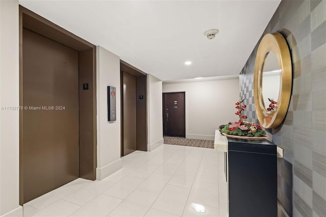 corridor featuring light tile patterned floors and elevator