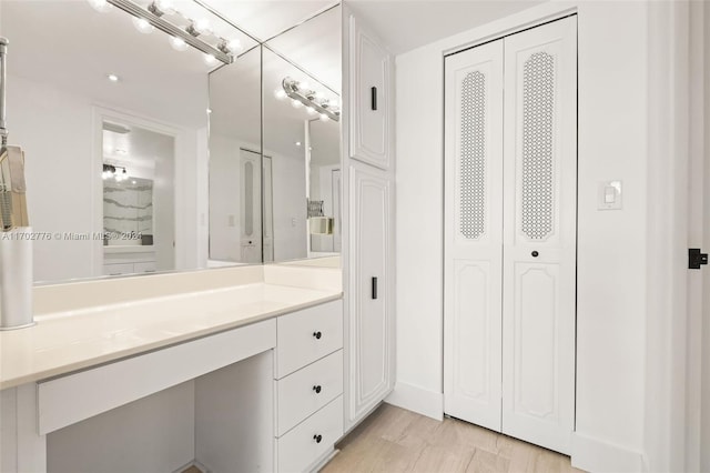 bathroom with hardwood / wood-style floors and vanity