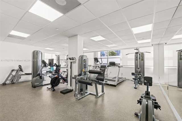 gym with a paneled ceiling