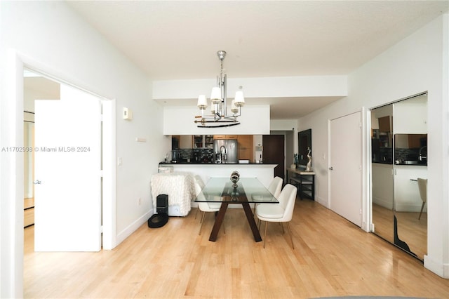 dining room featuring a notable chandelier and light hardwood / wood-style flooring