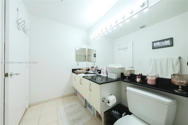 bathroom with tile patterned floors, vanity, and toilet