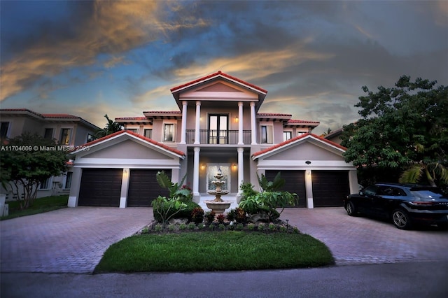 19363 SW 79th Ave, Cutler Bay, FL 33157 - mediterranean / spanish-style house featuring a garage, decorative driveway, stucco siding, and a balcony