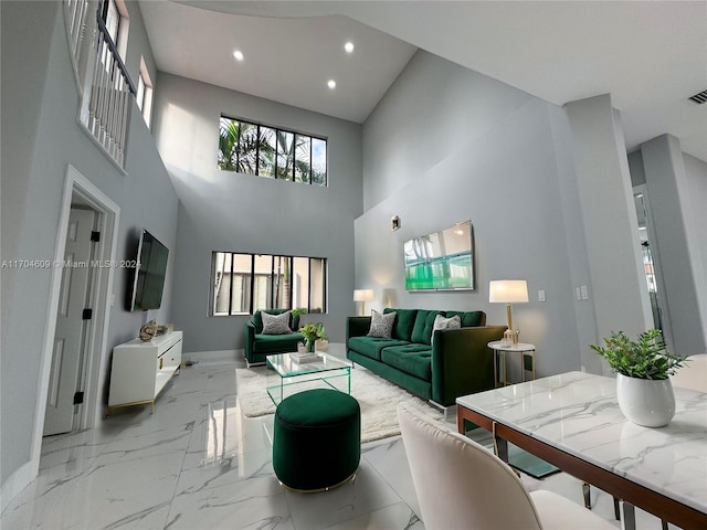 living room featuring a high ceiling