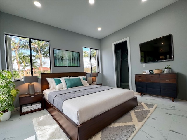 bedroom featuring a walk in closet and a closet