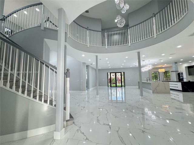 foyer featuring a chandelier and a high ceiling