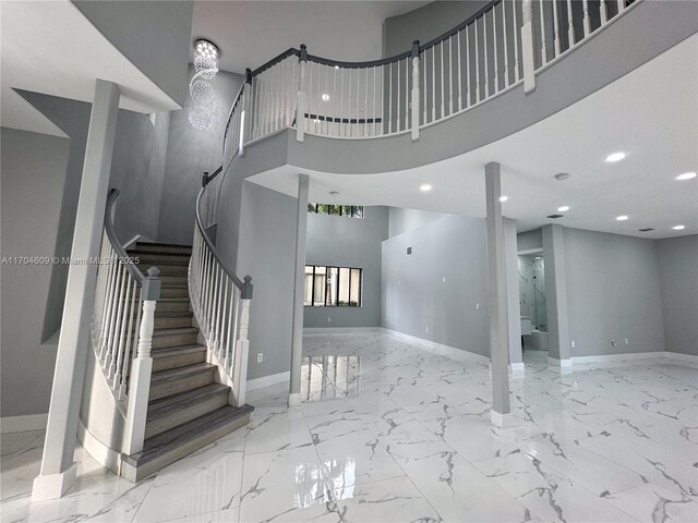 19363 SW 79th Ave, Cutler Bay, FL 33157 - stairway with baseboards, recessed lighting, a towering ceiling, and marble finish floor