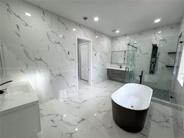 bathroom featuring vanity, tile walls, and plus walk in shower