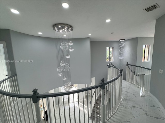 corridor with a notable chandelier