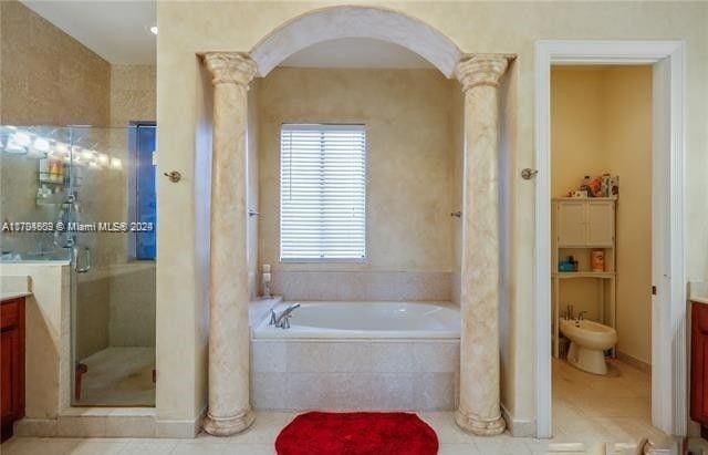 bathroom featuring vanity, a bidet, tile patterned flooring, separate shower and tub, and ornate columns